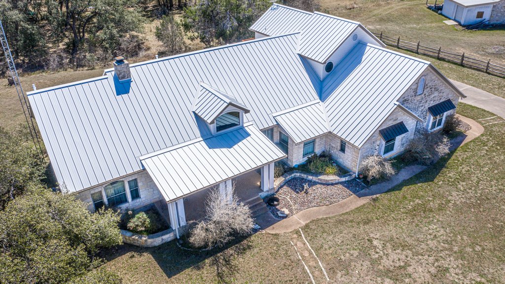 Aerial view of a completed standing seam metal roof in Central Texas