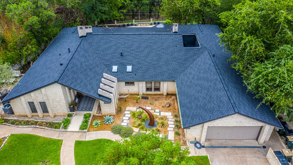 Aerial view of a completed residential shingle roof in Central Texas